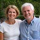 Portrait of a smiling couple, David and Sarah Chen, by their new outdoor kitchen.