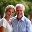 Portrait of a smiling couple, The Millers, in their backyard.